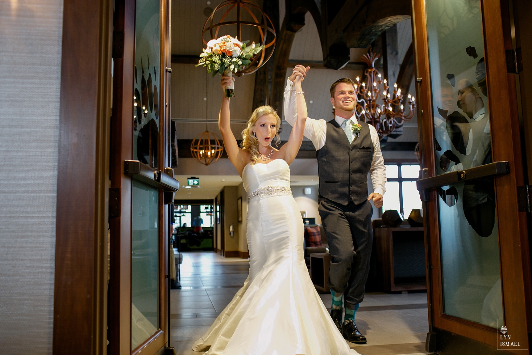 The bride and groom enters the Fall's Room at Whistle Bear Golf Club