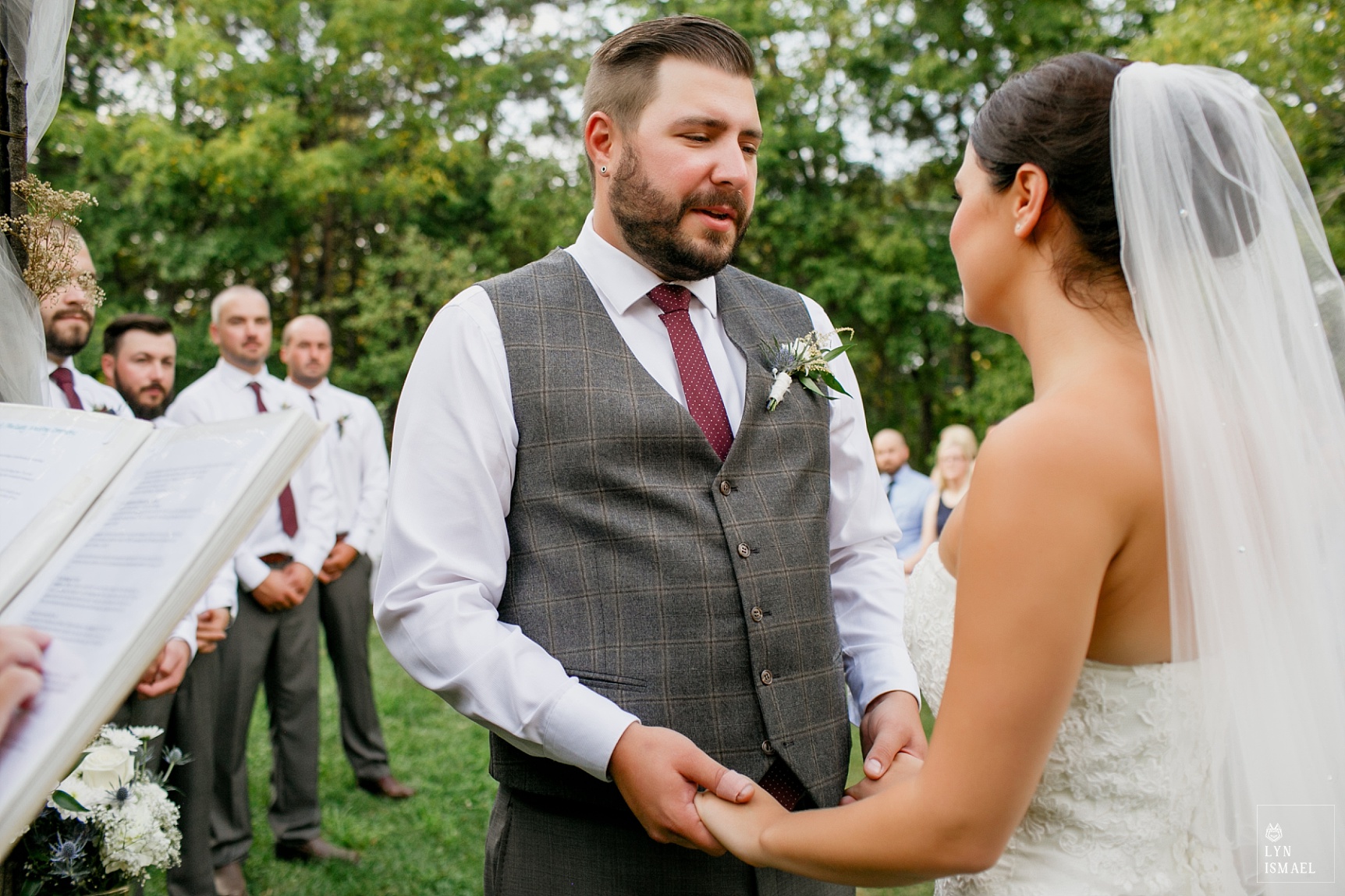 Bride and groom exchanges vows at their apple orchard wedding ceremony at Steckle Heritage Farm