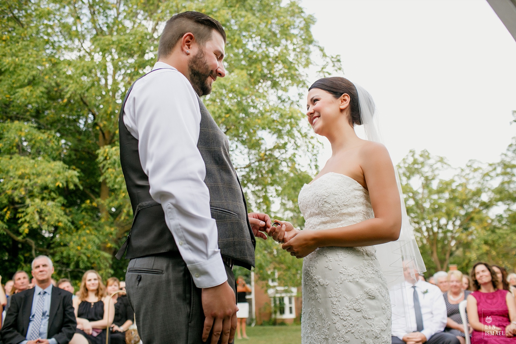 Bride and groom exchanges rings at an outdoor wedding ceremony at Steckle Heritage Farms in Kitchener, Ontario