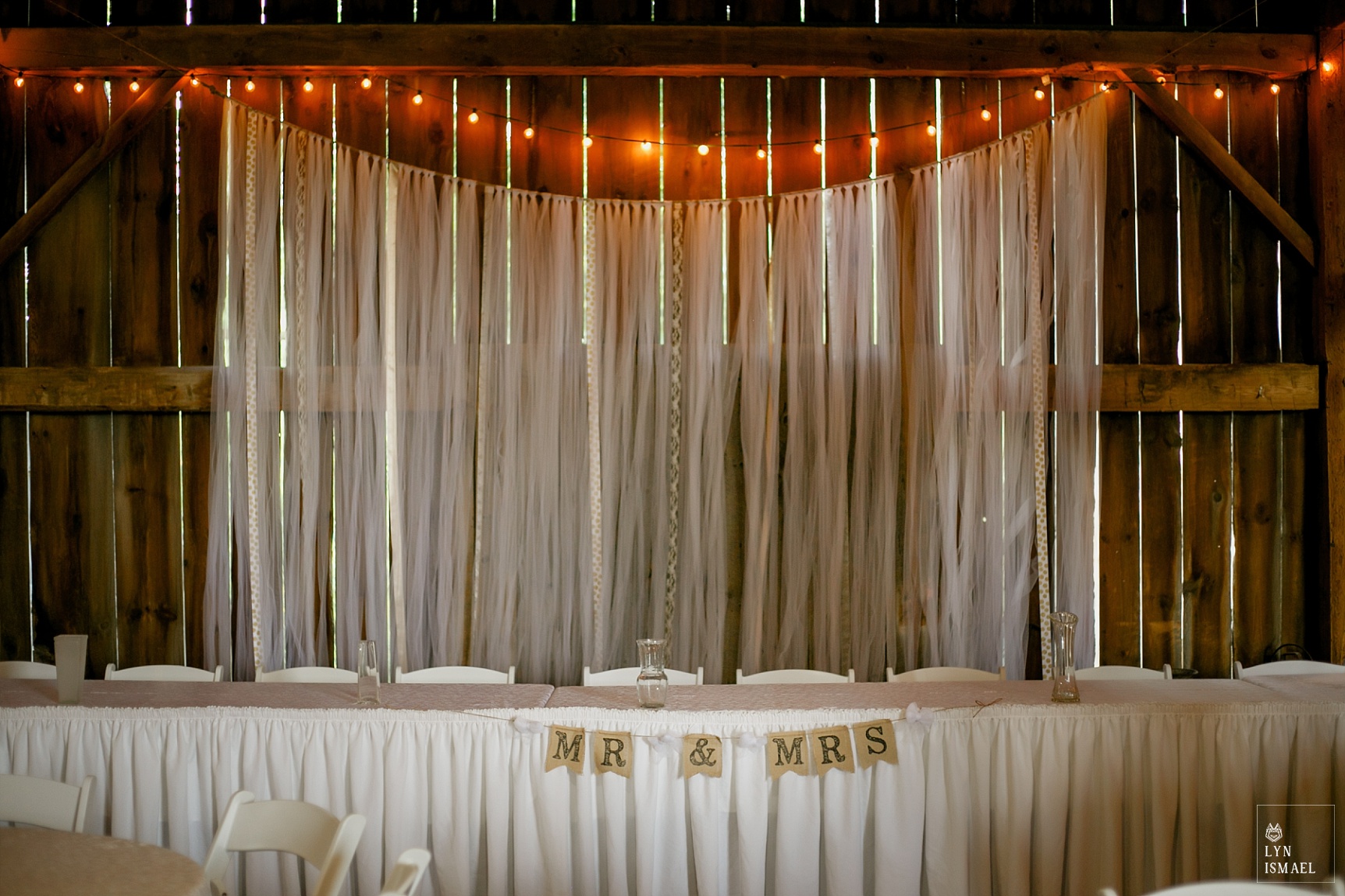 Ribbons and string lights at a barn wedding at Steckle Heritage Farms