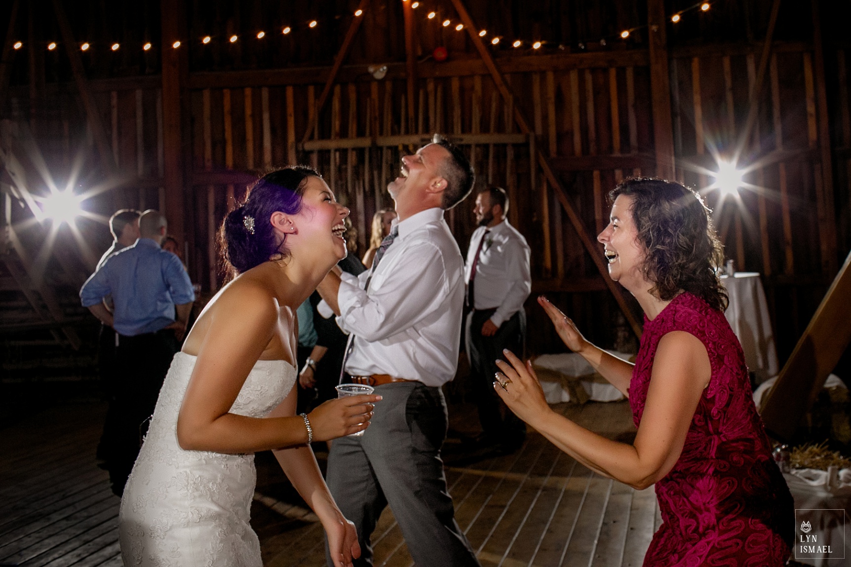 Bride and her mother dances with wedding guests