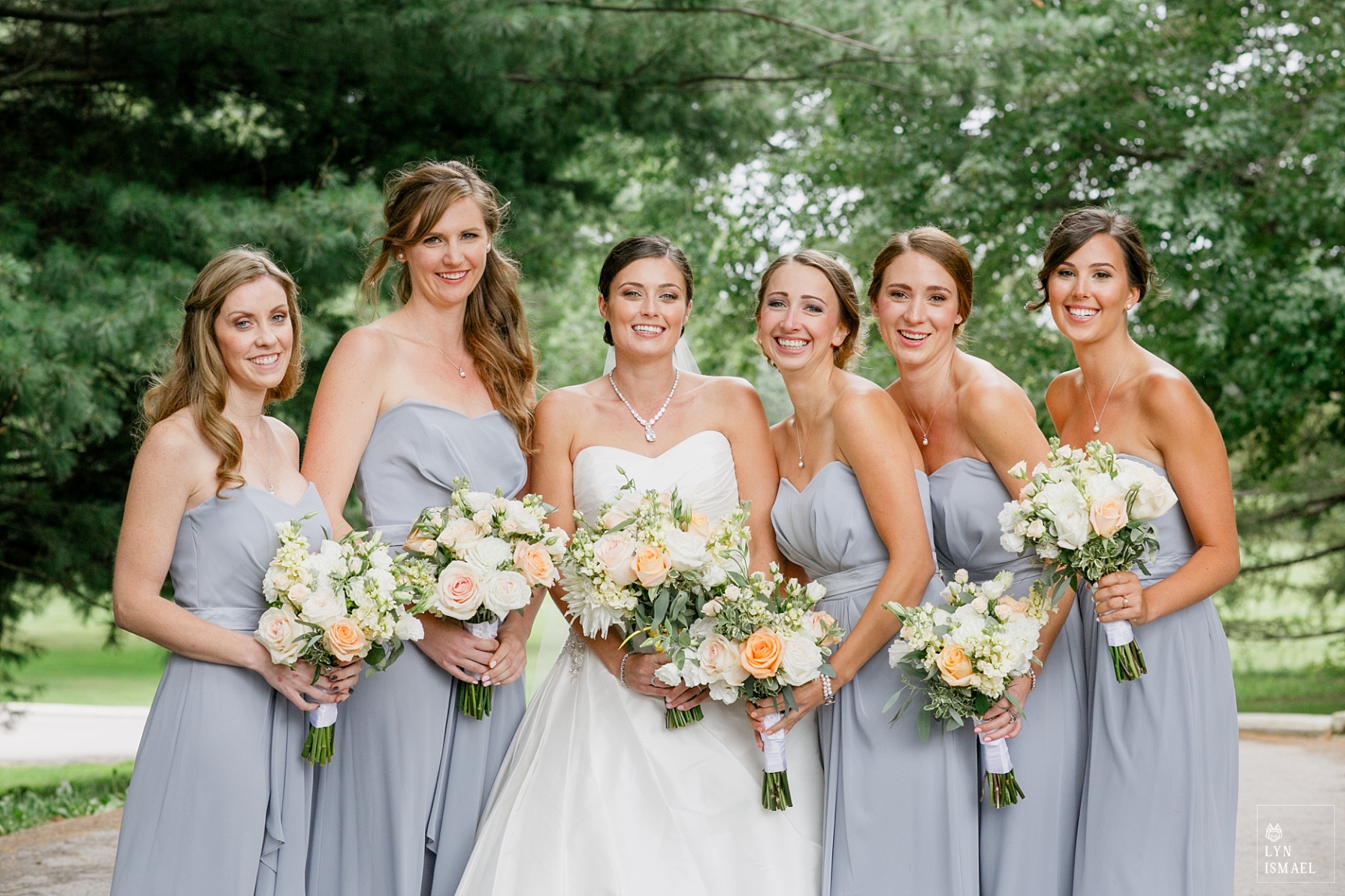 Bride and bridesmaids in bue-gray dresses