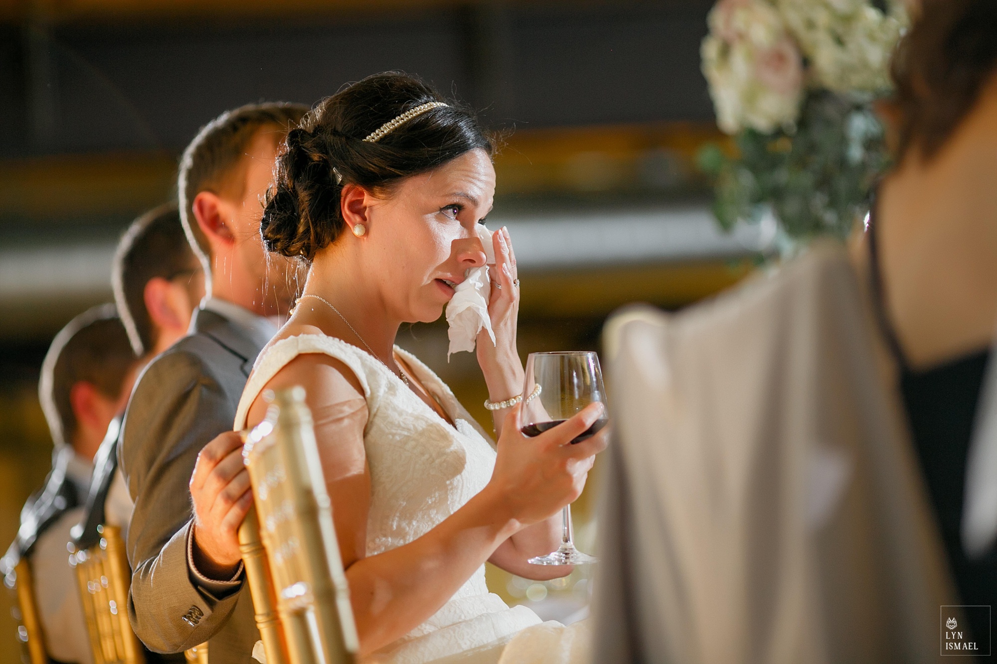 Bride wipes away her tears
