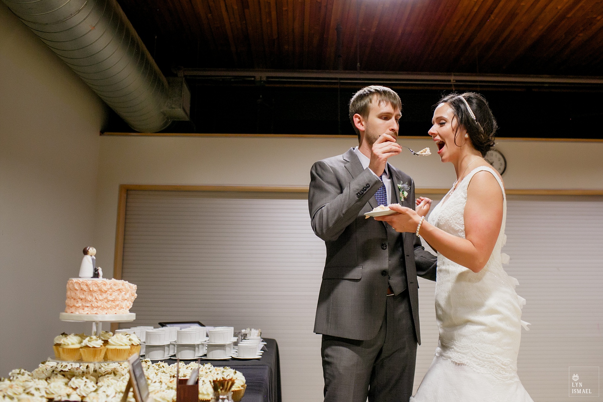 Bride and groom feed each other cake at their wedding reception at THEMUSEUM in Kitchener.