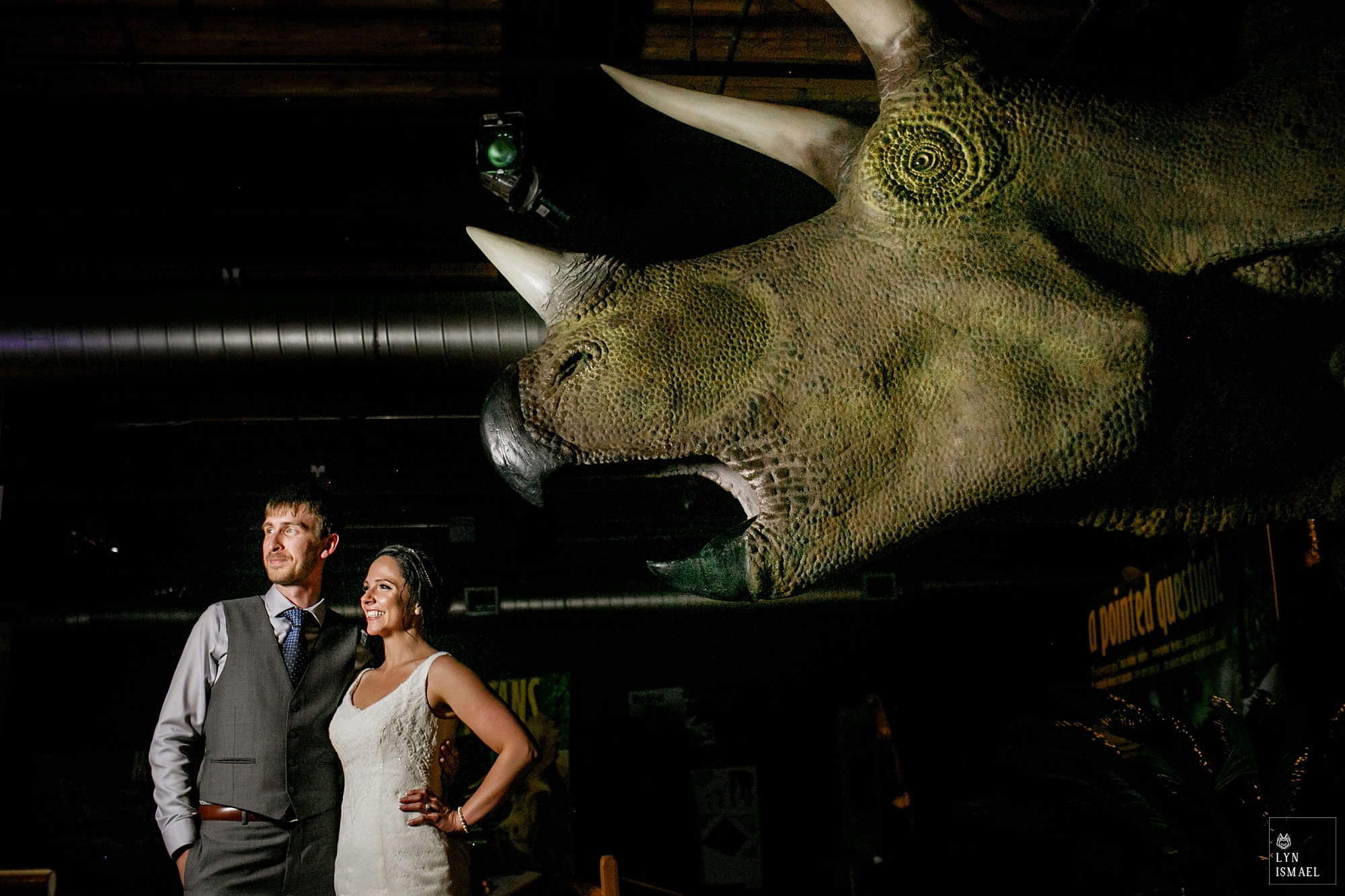 Photo of the bride and groom with a triceratop