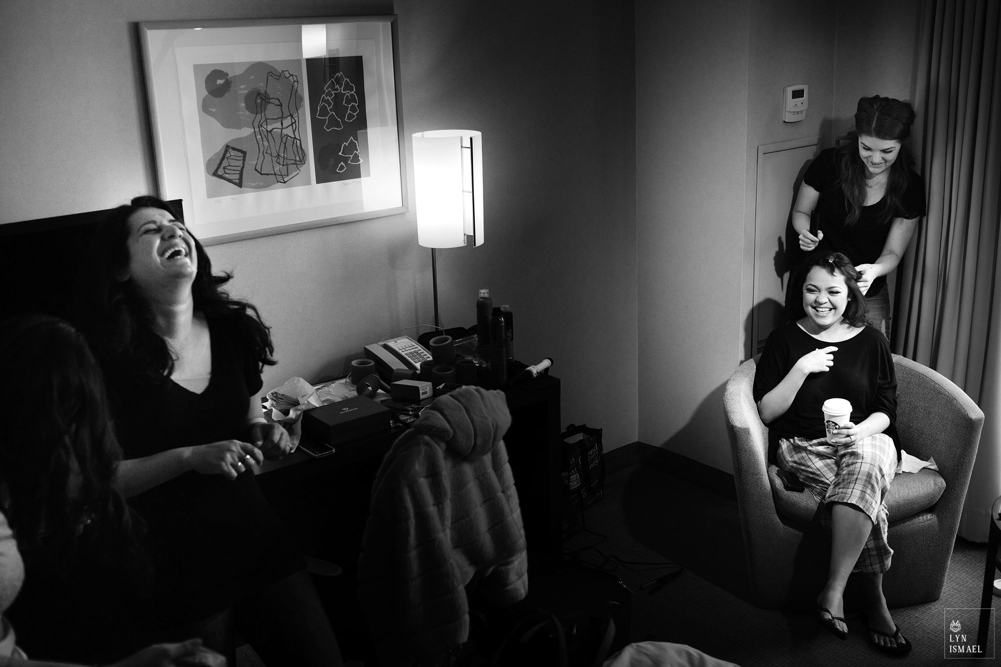 Bride and her friend laughs at the same inside a hotel room at the Novotel Hotel Toronto Centre