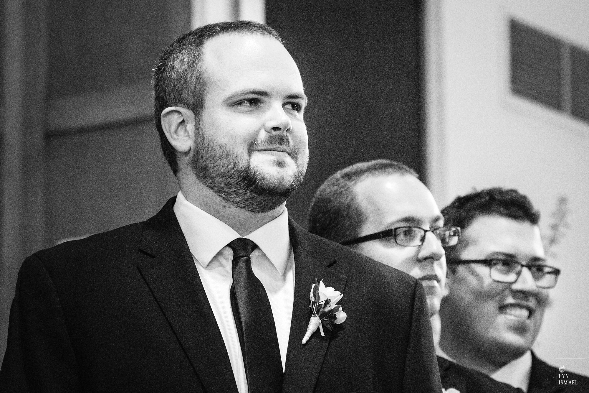 Groom watches his bride walk down the aisle at a Kitchener Mennonite Brethren Church wedding.