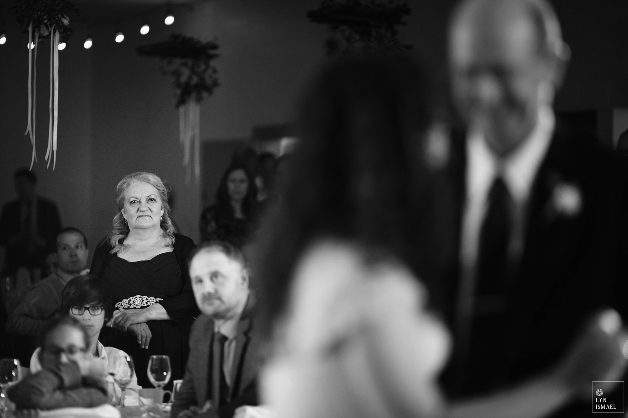 Mother of the bride watches father-daughter dance