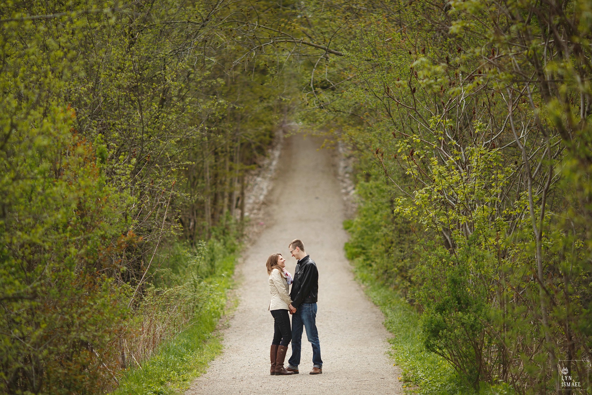 An engaged couple poses for their portrait in Huron Natural Area i Kitchener.