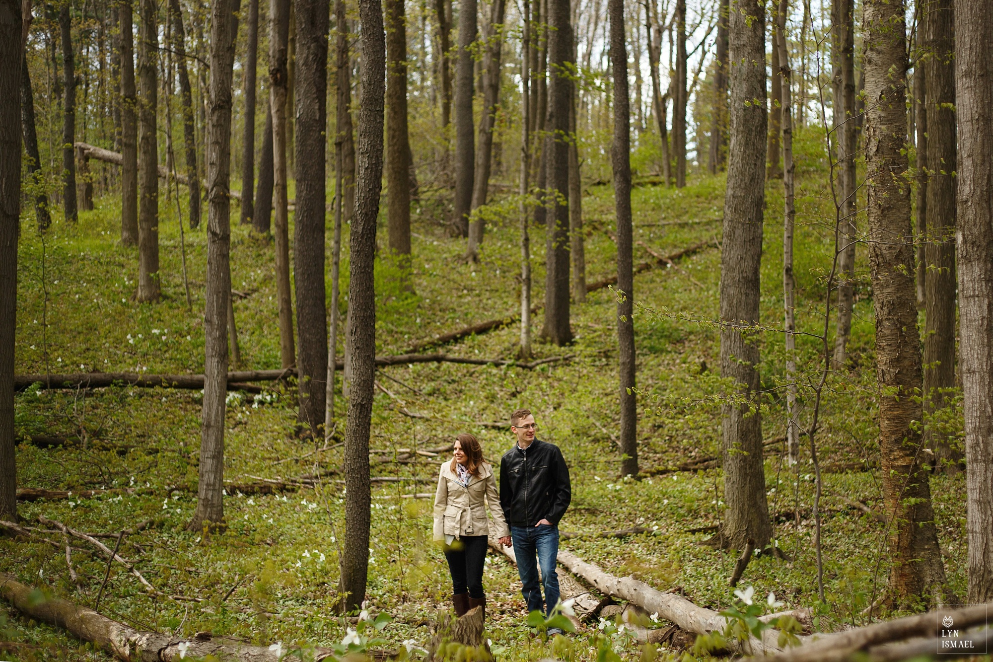 A couple poses for a portrait in the forest in Kitchener, Ontario
