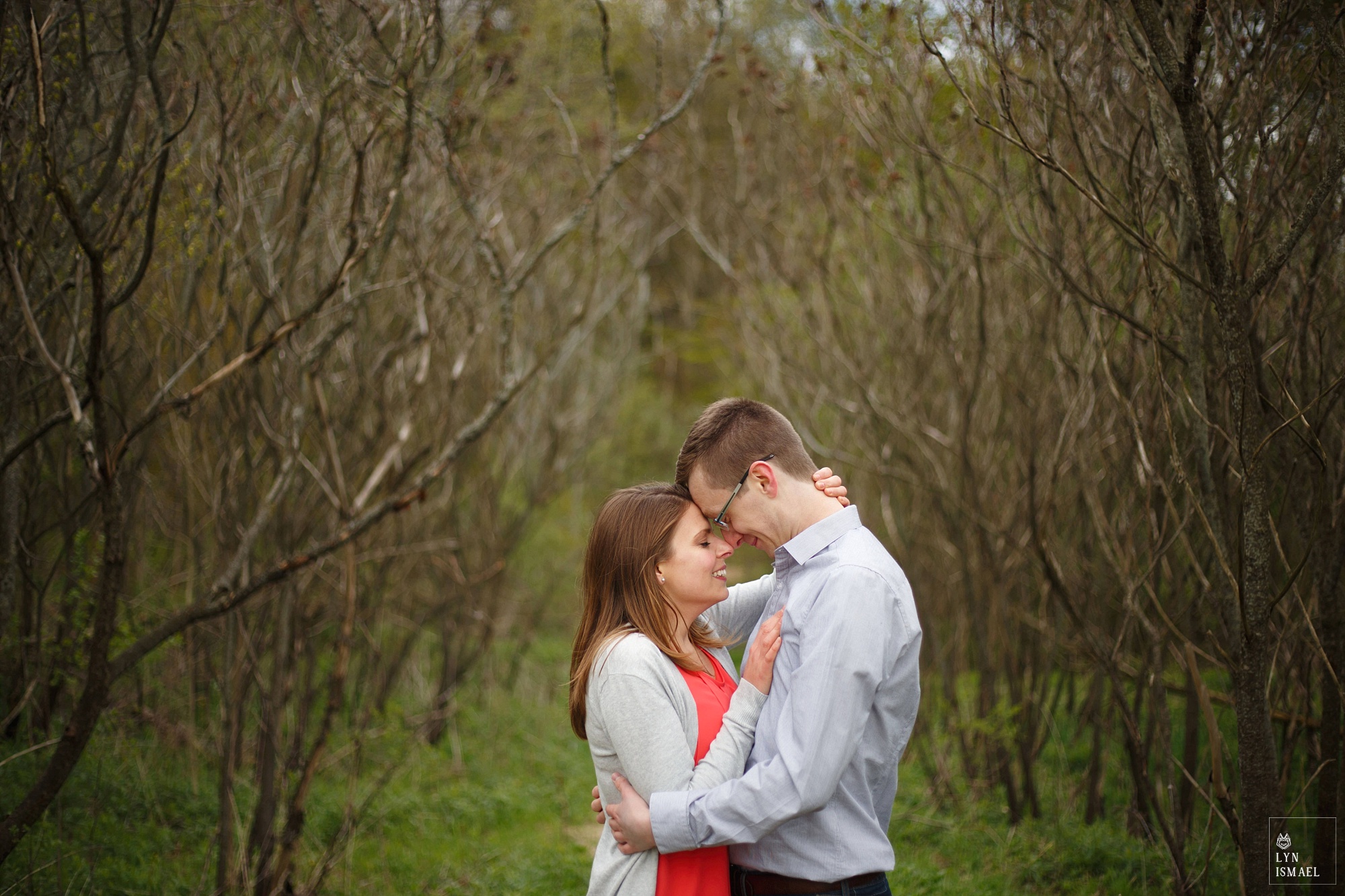 Engaged couple in the middle of the woods in Kitchener, Ontario photographed by Kitchener wedding photographer.