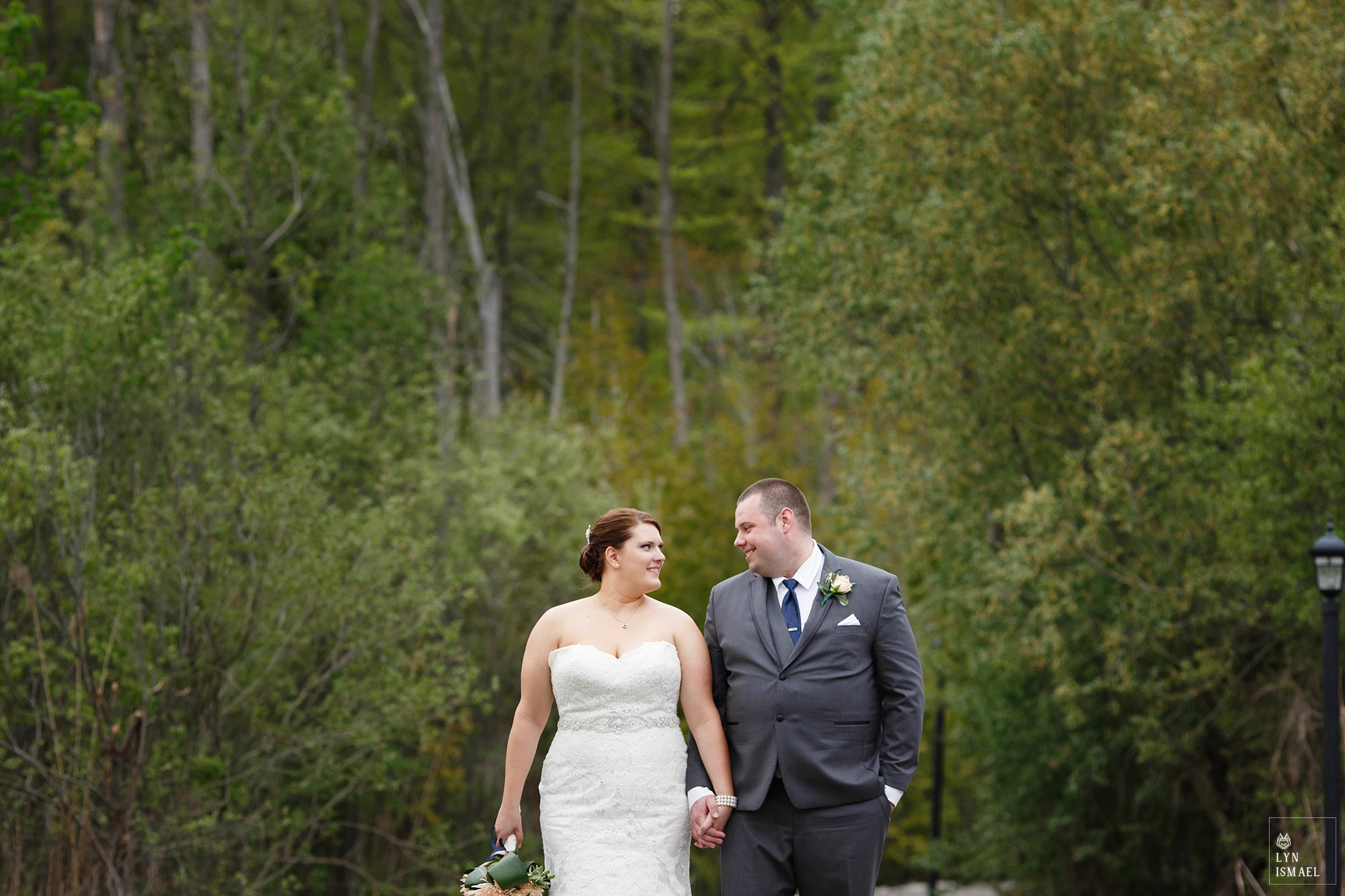 Bride and Groom poses in the wooden area at Whistle Bear Golf Club