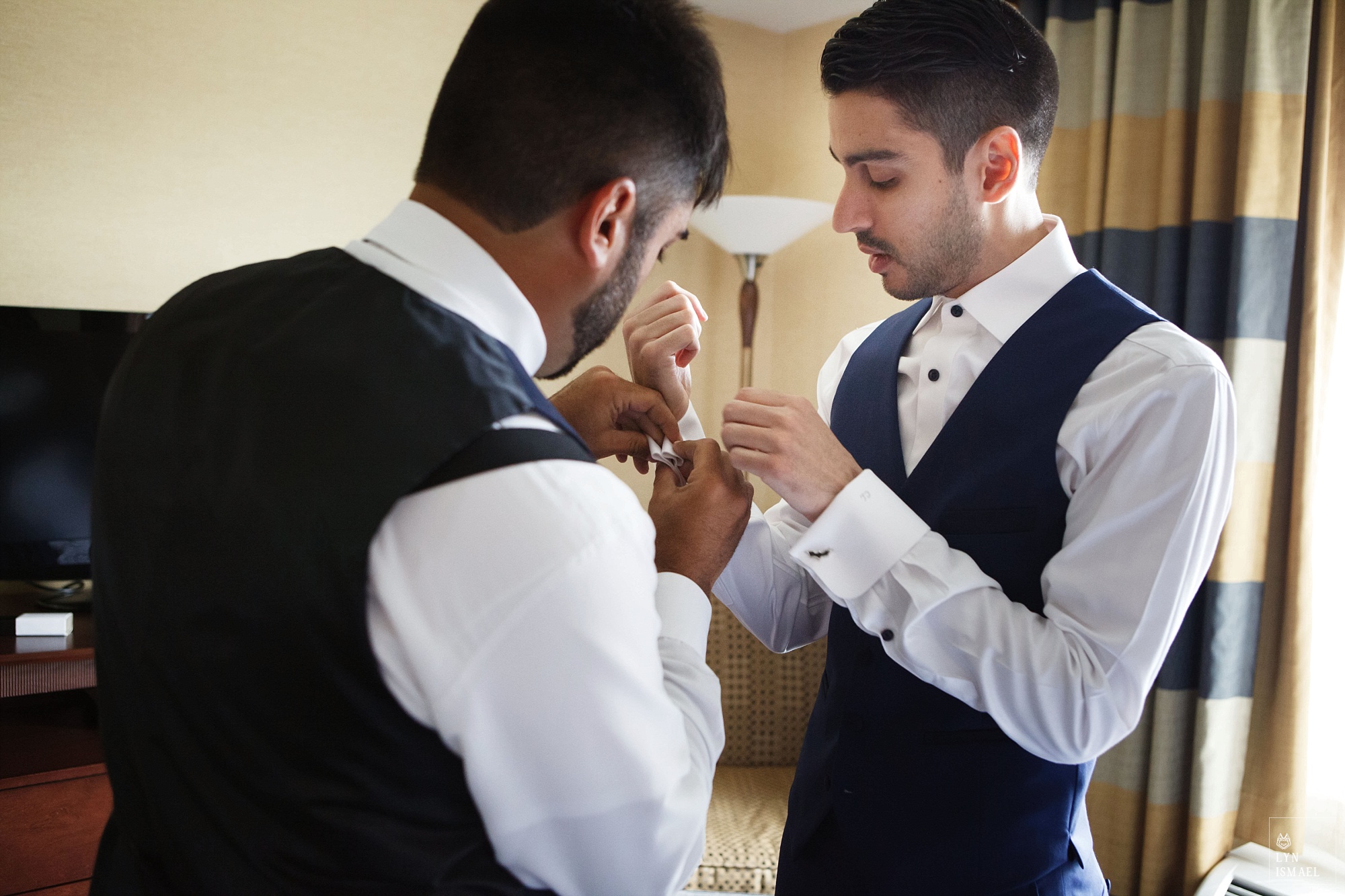 Best Man helps the groom get ready.