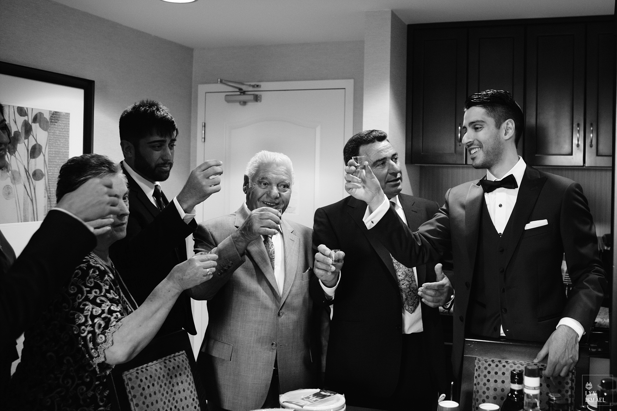Groom toasts with his family the morning of his wedding.