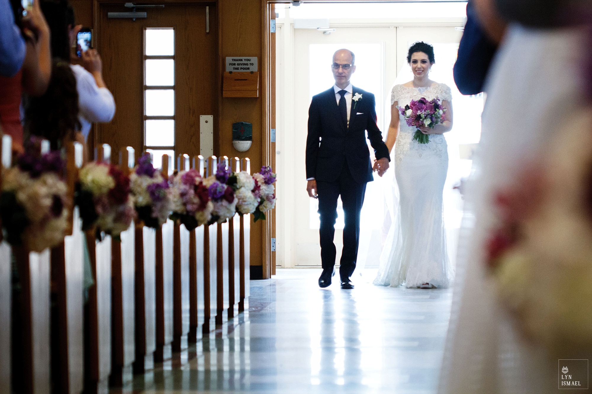 Bride and her father walks down the aisle.