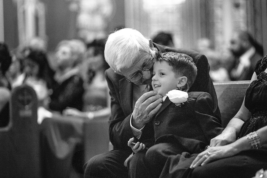 Toronto wedding photographer photographs an intimate moment between a grandfather and his grandson during a Toronto wedding ceremony.