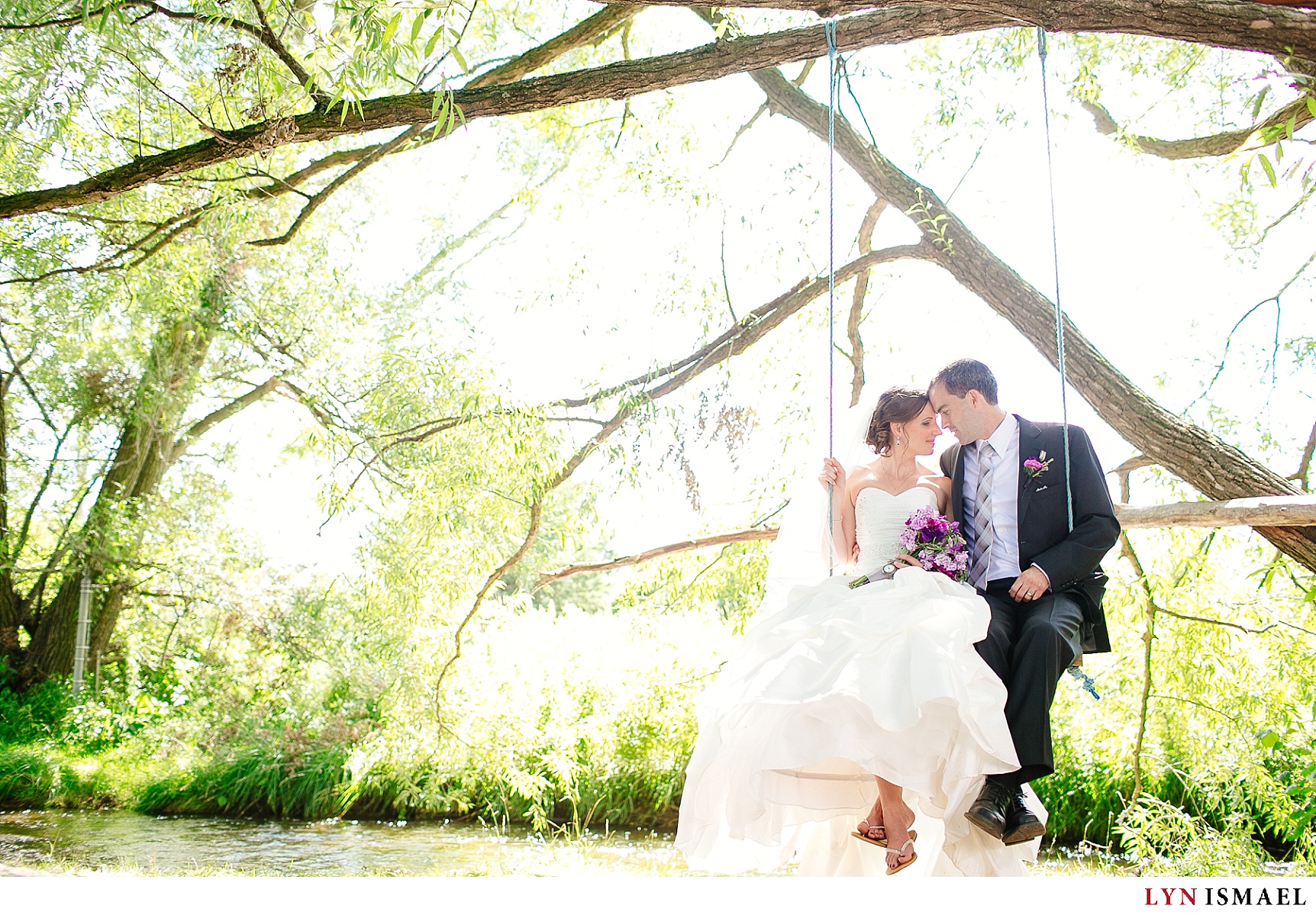 A romantic photo of the bride and groom on a swing.