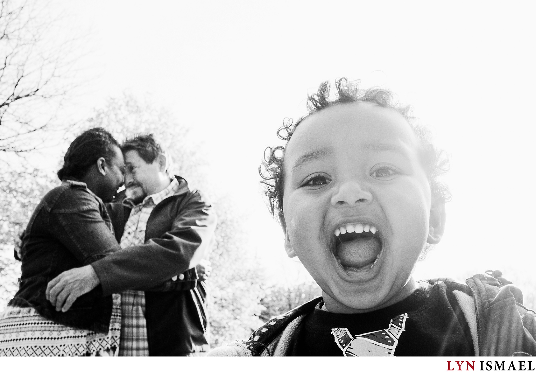A fun portrait of a toddler and his parents at his parents' engagement session.