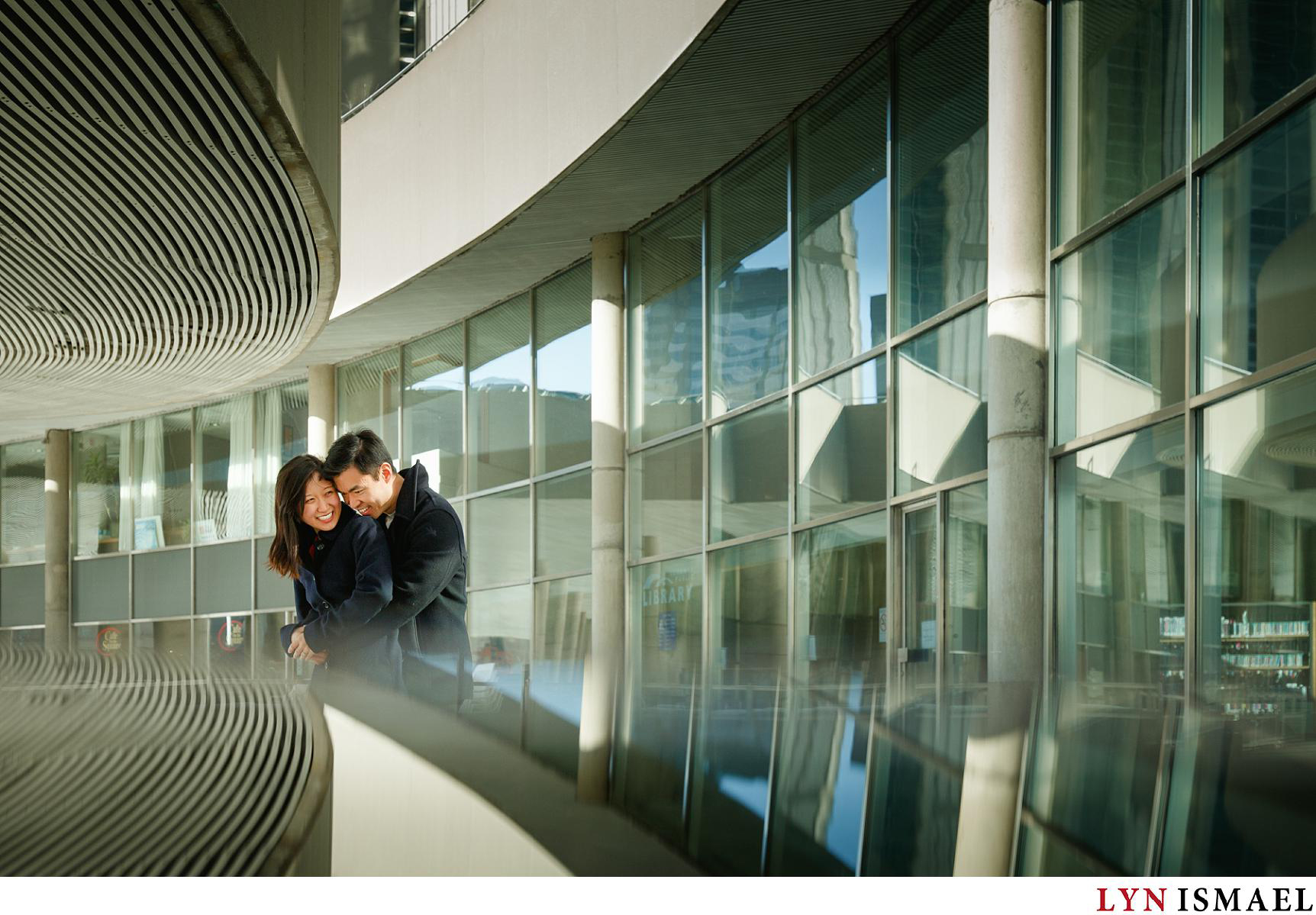 A gorgeous young Asian couple using nathan Phillips Square as a setting for their urban engagement session.