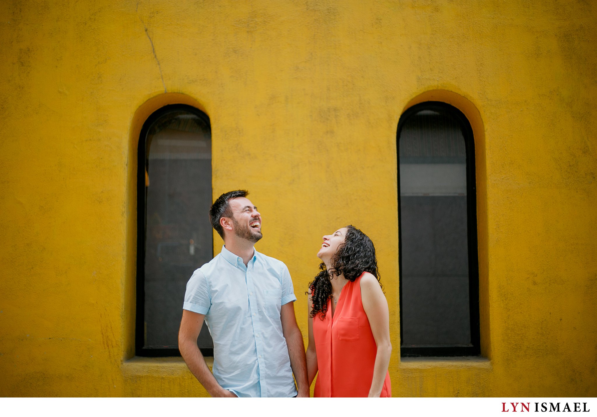 an engaged couple in Toronto shares a laugh at their Engagement session at Toronto's St Lawrence Area