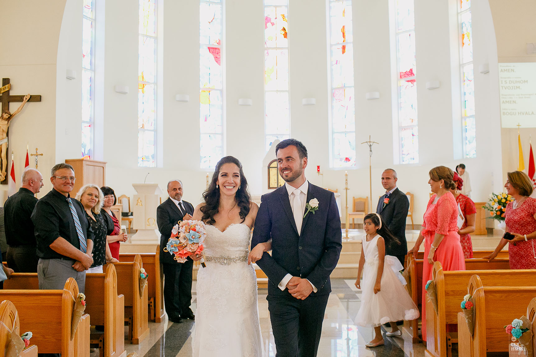 newly wed couple walk down the aisle to help an article about photography restrictions at church weddings